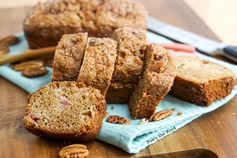 Cinnamon Streusel Rhubarb Bread sliced with pecans around.