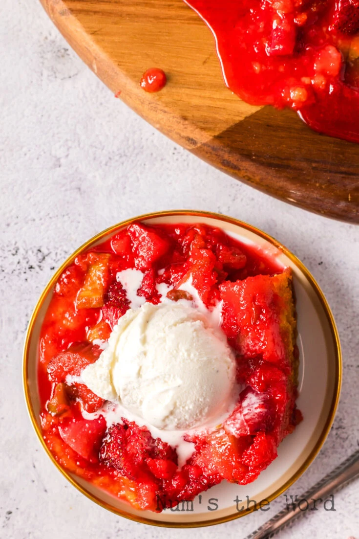 A slice of cake on a plate with a scoop of vanilla ice cream.