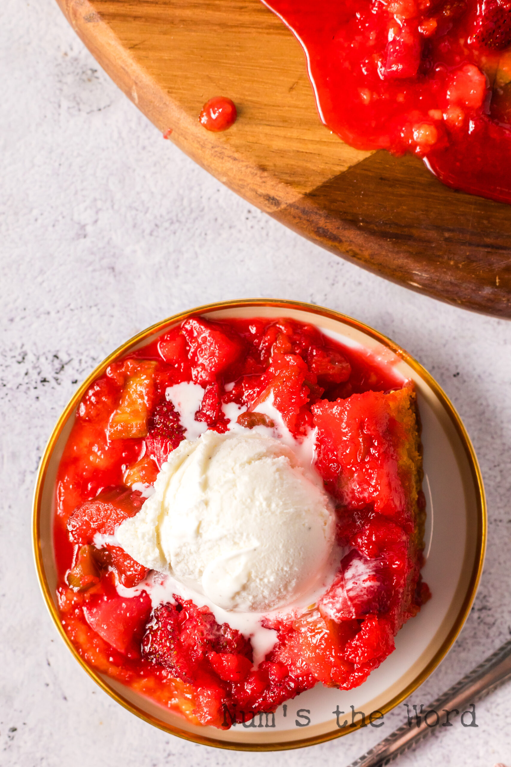 A slice of cake on a plate with a scoop of vanilla ice cream.