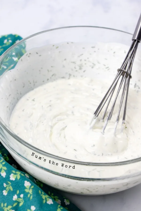 sour cream, salt, vinegar, dill weed, sugar and black pepper in a bowl, mixed to a cream sauce.