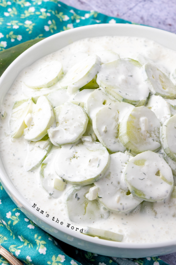 Chilled and prepared creamy cucumber salad in a serving bowl.