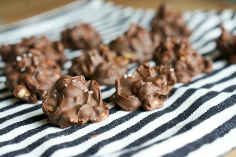 Chocolate Peanut Clusters - chocolates layed out on cloth napkin.