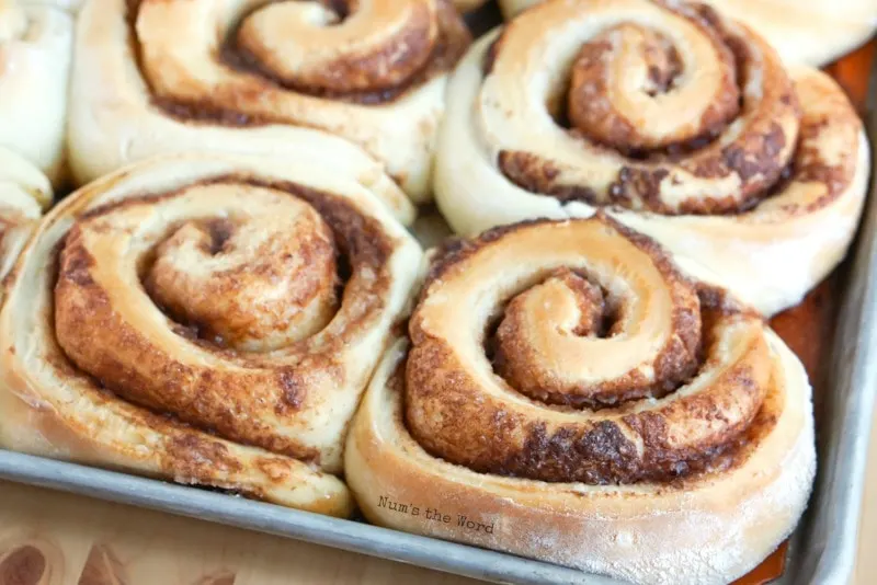 Leftover Mashed Potato Cinnamon Rolls - close up of cinnamon rolls on baking sheet after baked