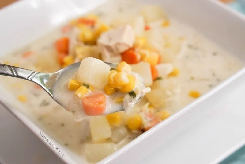 Creamy Chicken & Potato Soup - soup in a bowl with spoonful of soup