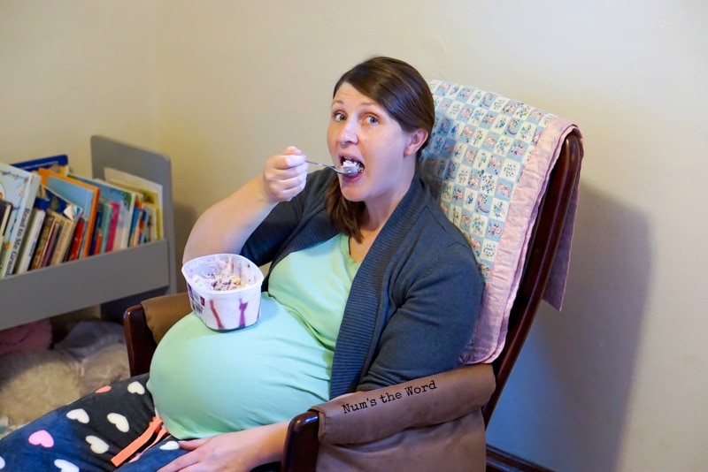 How to Keep a Pregnant Woman Happy - Janelle shoving ice cream into her mouth with tub sitting on large pregnant belly