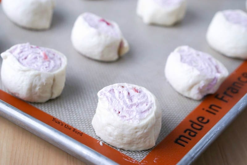 Leftover Cranberry Sauce Roll Ups - close up of sliced roll ups on cookie sheet, not baked