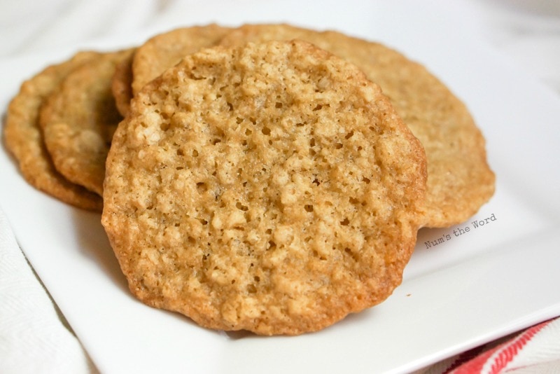 Chewy Oatmeal Lace Cookies - cookies on a plate with one propped up against the others.