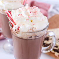 top side view of two glasses of hot chocolate with whipped cream and peppermint