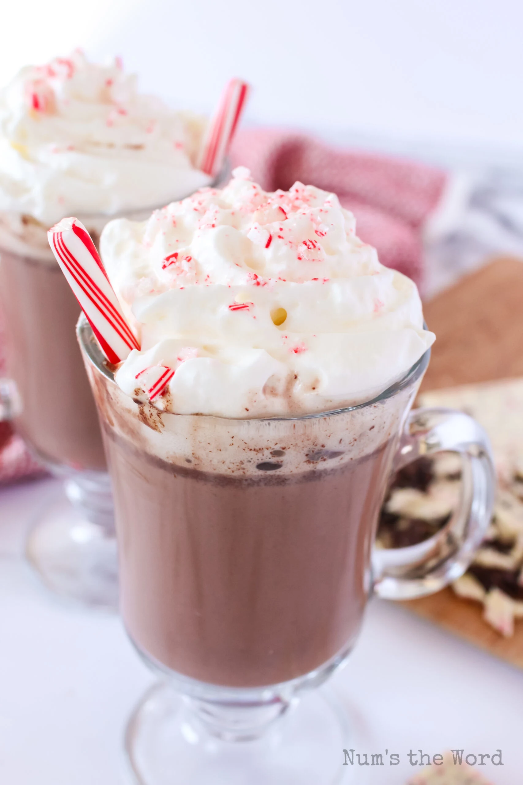 top side view of two glasses of hot chocolate with whipped cream and peppermint