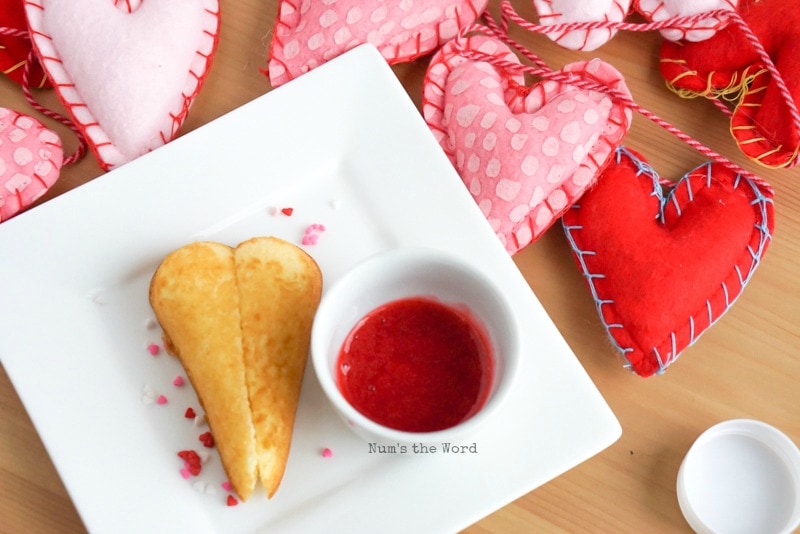 Twinkie Hearts - Twinkie Heart on plate with a small condiment cup full of raspberry puree