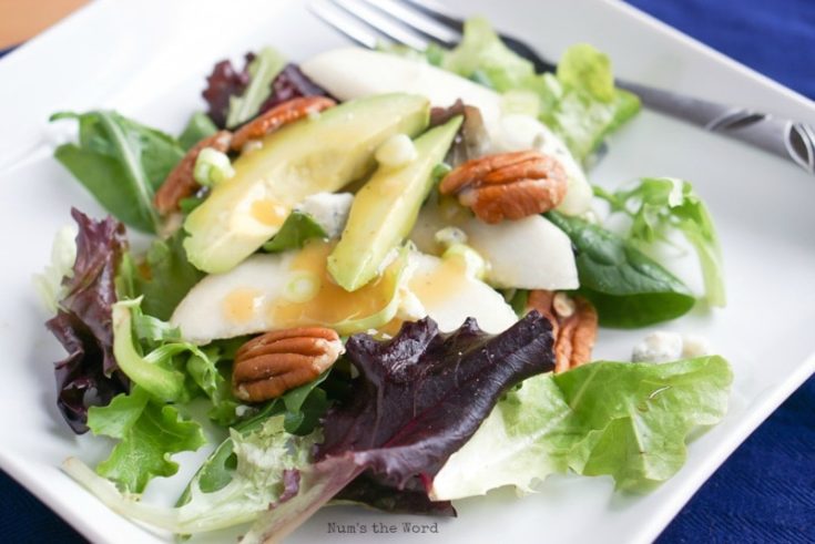 Roquefort Pear Salad - salad on plate with dressing on it