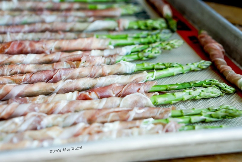 Prosciutto Wrapped Asparagus - Asparagus ready to be cooked. Photo taken from side.