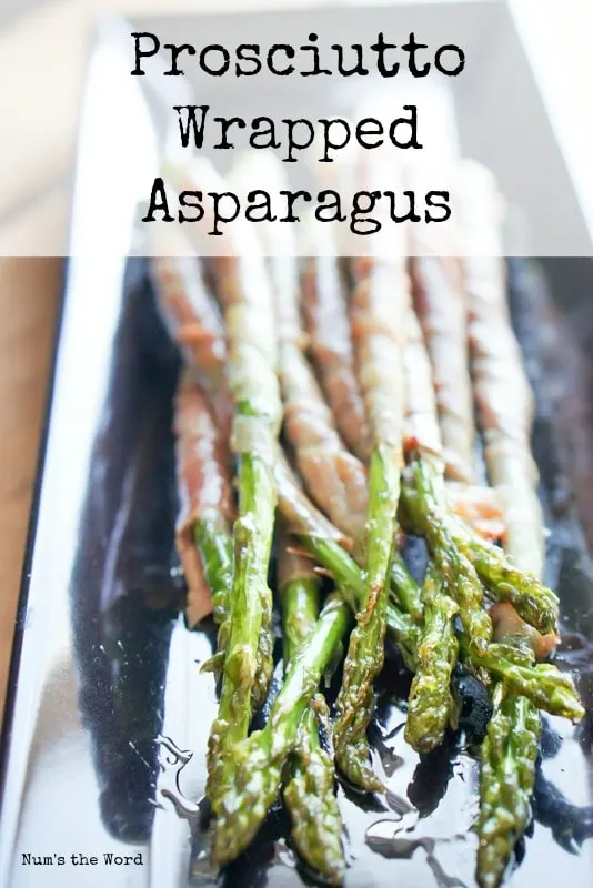 Prosciutto Wrapped Asparagus - Main image for recipe. Cooked prosciutto wrapped asparagus on a serving platter facing the camera.