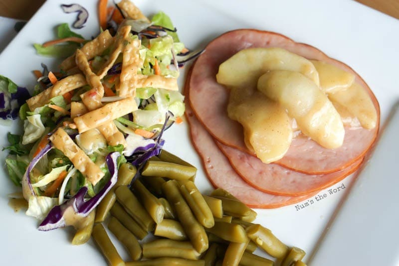 Ham Steaks with Sauteed Apples - a plate full of food. Green beans, a green salad and the ham steaks with sauteed apples.