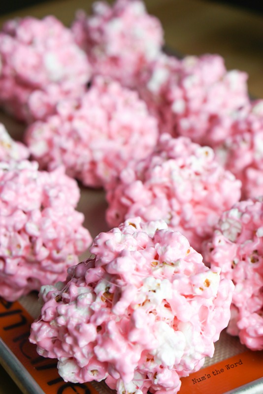 popcorn balls placed on a baking sheet