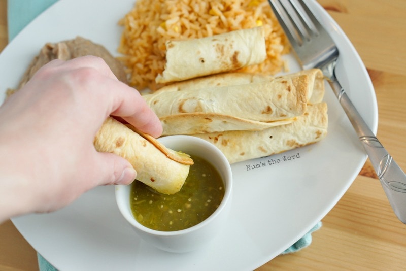 Pulled Pork Flautas - hand dipping cut flauta into salsa verde