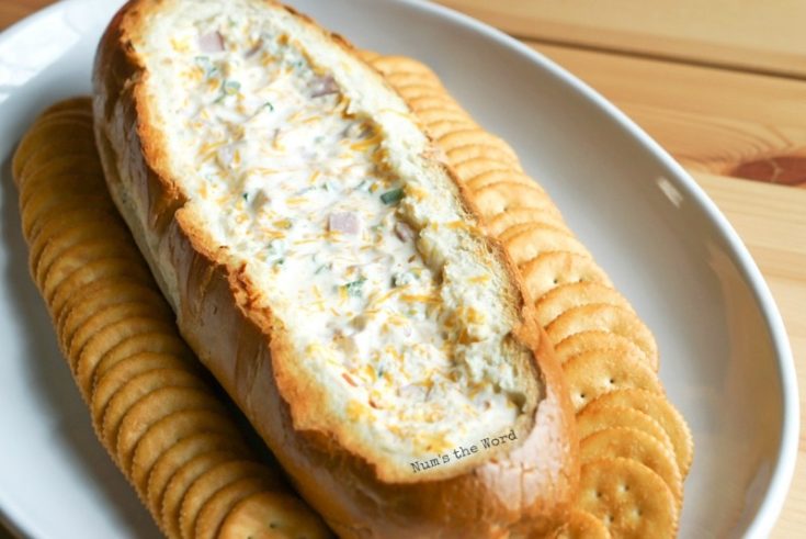 Cheesy Ham Dip in a Bread Bowl - cooked dip ready to be eaten. Photo taken from end of bowl looking back.