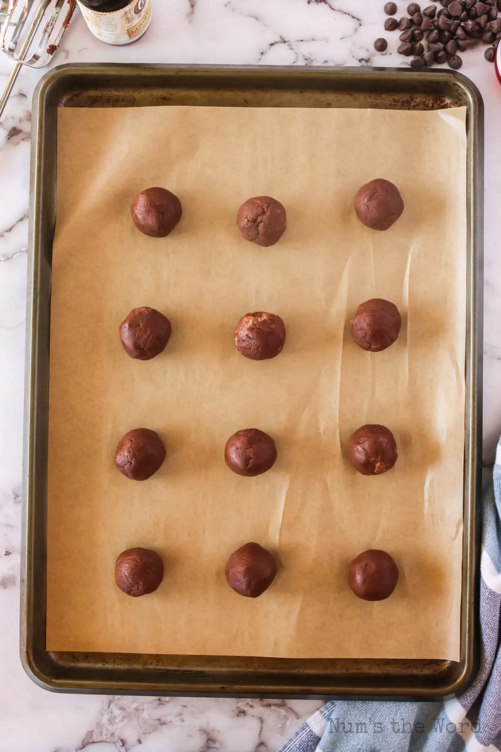 cookie dough balls placed on lined cookie sheet