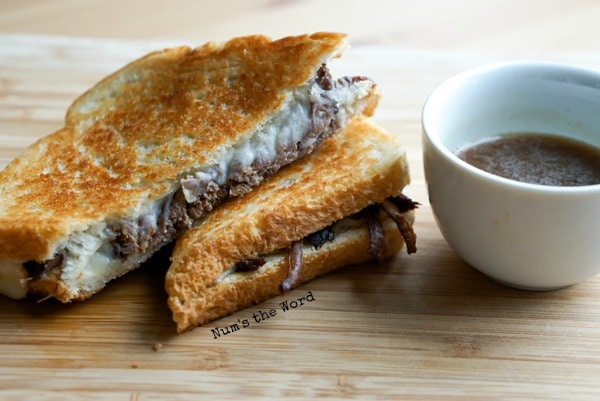 Leftover Pot Roast Grilled Cheese - sliced sandwich on plate with dip