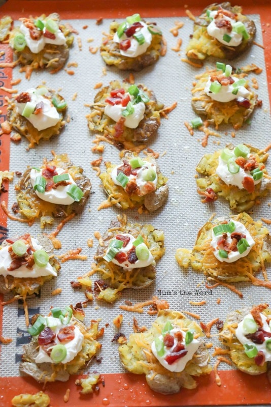 Loaded Smashed Potatoes - fully loaded potatoes baked and ready to be eaten all on tray