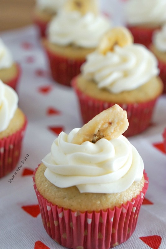 Banana Cupcakes - cupcakes laid out with one in front. Banana chip is tilted