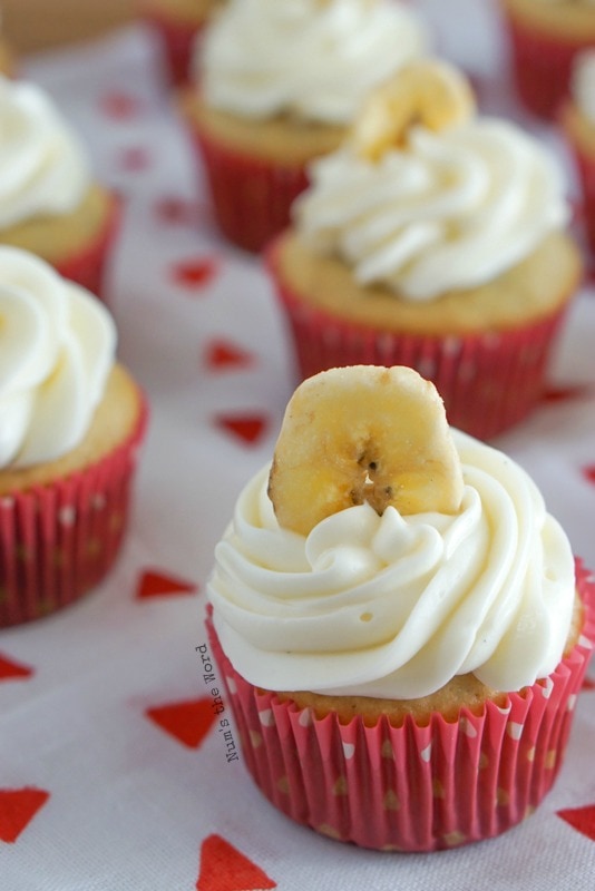 Banana Cupcakes - cupcakes laid out with one in front. Banana chip is on perfect
