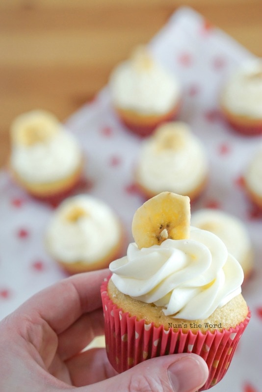 Banana Cupcakes - Portrait photo of hand holding one to show up close to camera.
