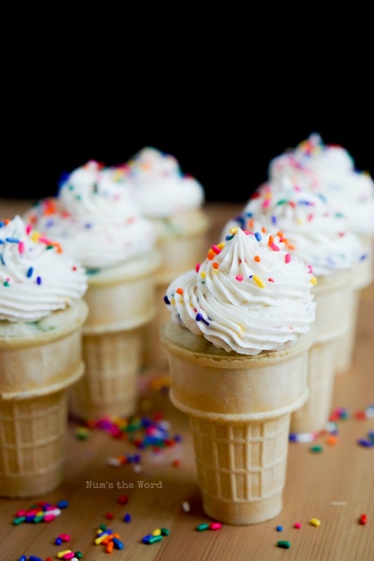 Funfetti Buttercream Frosting - side angle of frosted cupcakes in ice cream cone