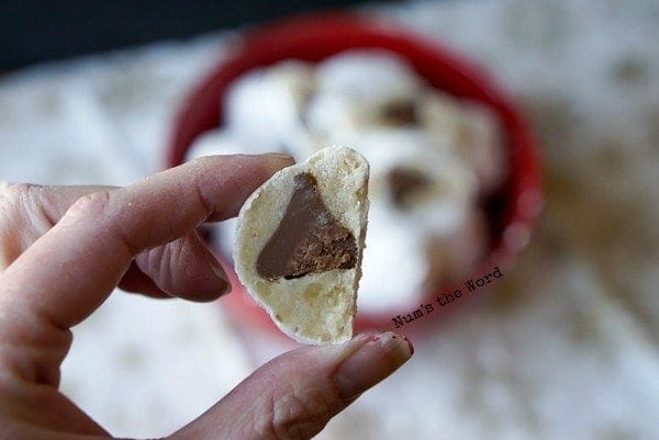 Surprise Snowball Cookies - snowball cookie cut in half to show chocolate kiss inside