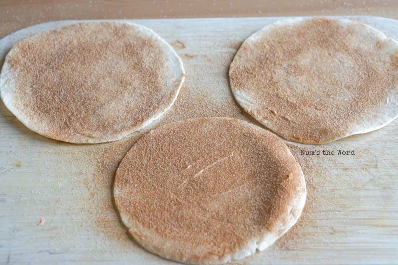 Cinnamon Sugar Tortilla Chips - tortillas on cutting board covered in sugar.