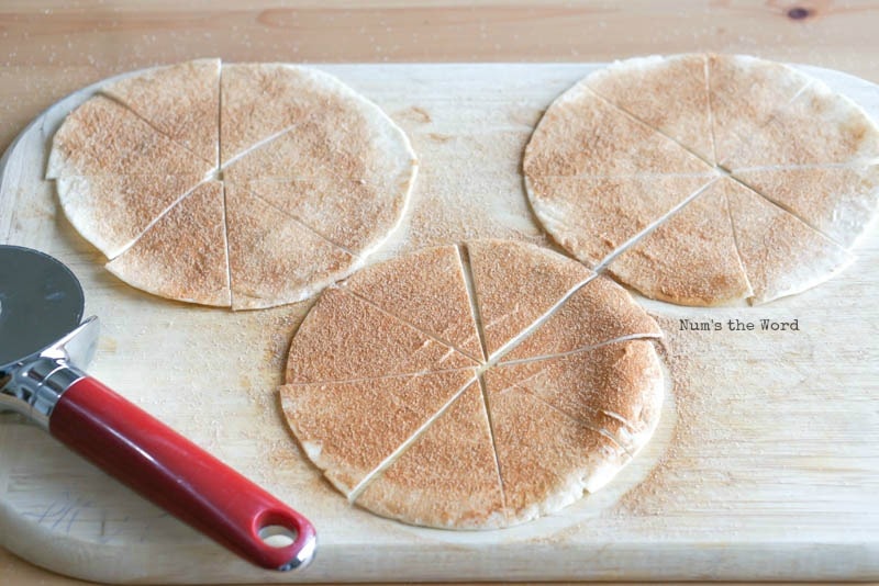 Cinnamon Sugar Tortilla Chips - tortillas on cutting board topped with sugar and cut like a pizza