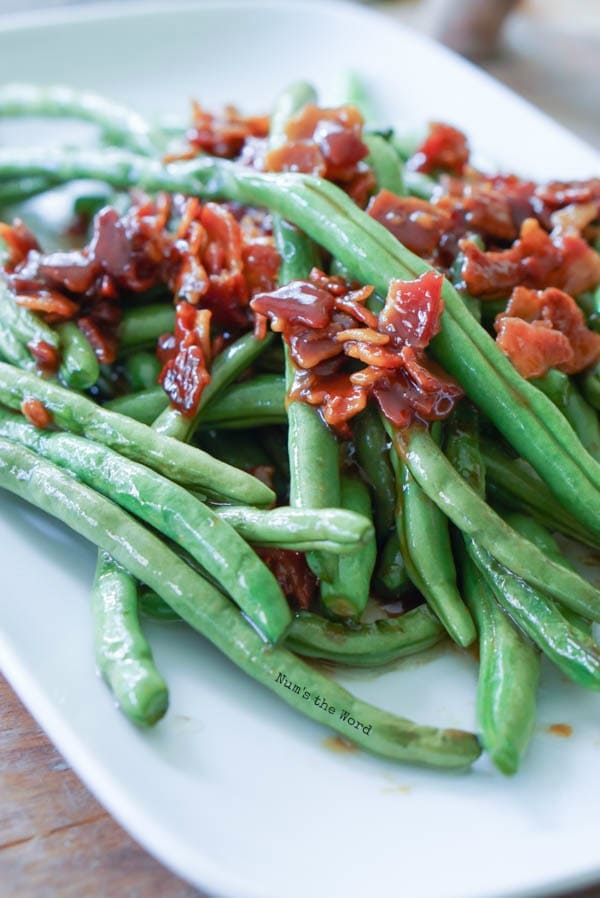 Brown Sugar & Bacon Green Beans - side view of bacon and green beans on plate