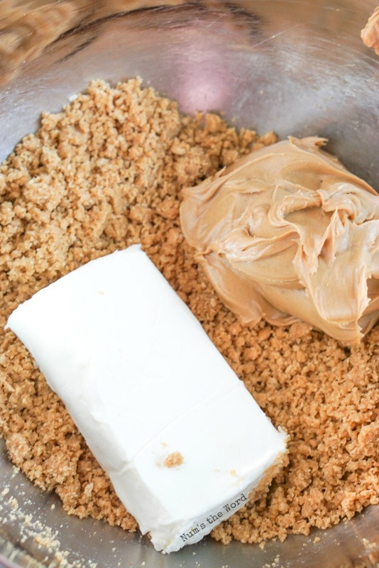 Peanut Butter Cup Truffles - Graham Cracker mix with cream cheese and peanut butter on top - not yet mixed.