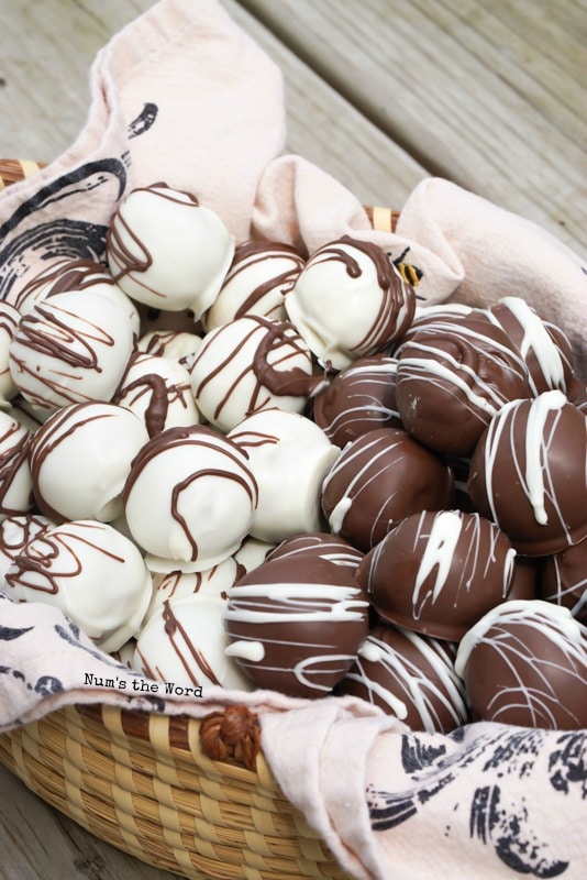 Peanut Butter Cup Truffles - truffles in a basket. Some covered in white chocolate, others in dark.