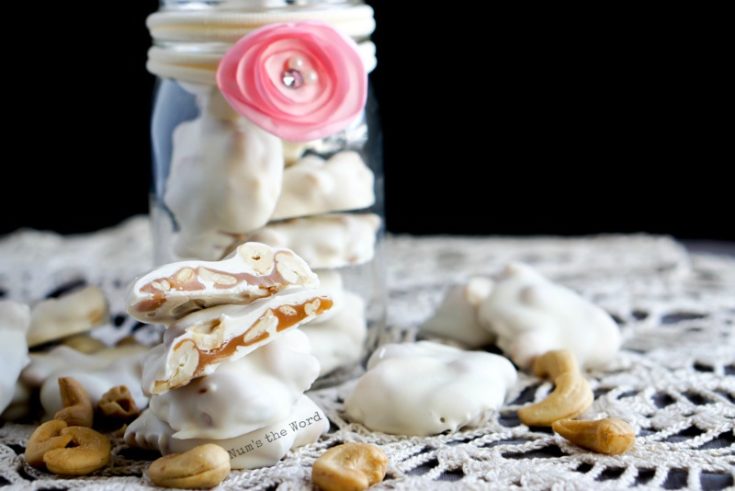 Caramel Cashew Clusters - clusters in a jar with some spread around jar and one sliced open to see insides.