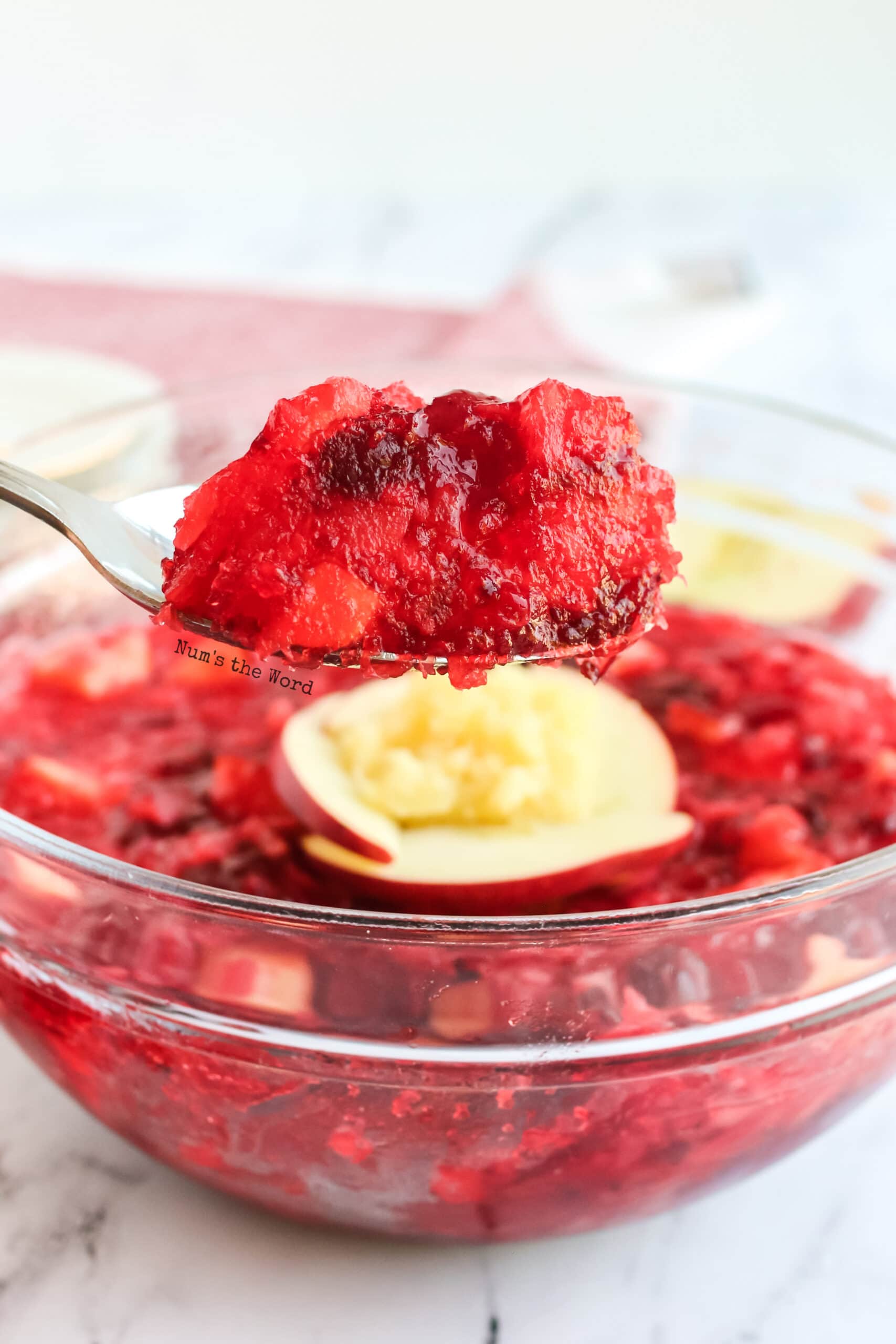 large spoon full of jello with bowl in background