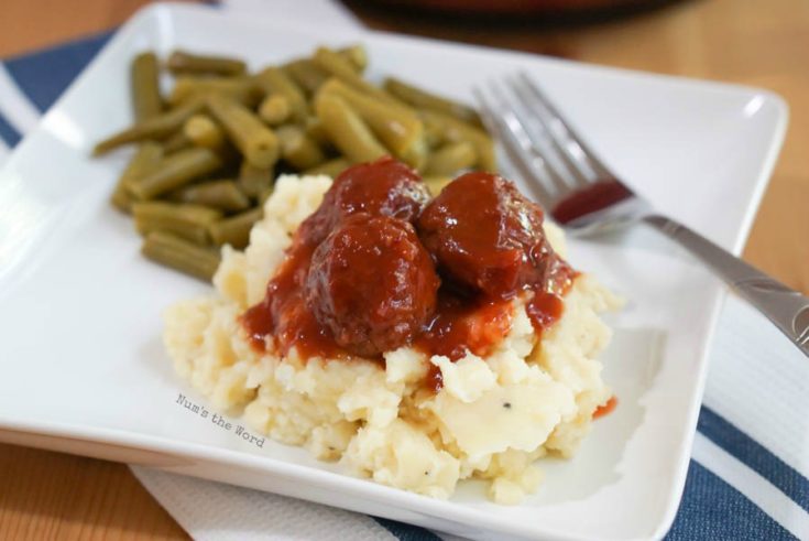 Chili Cranberry Meatballs - side view of meatballs on plate over mashed potatoes.