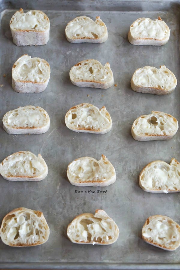 Leftover Cranberry Sauce Bruschetta - butter spread on top of each slice of bruschetta