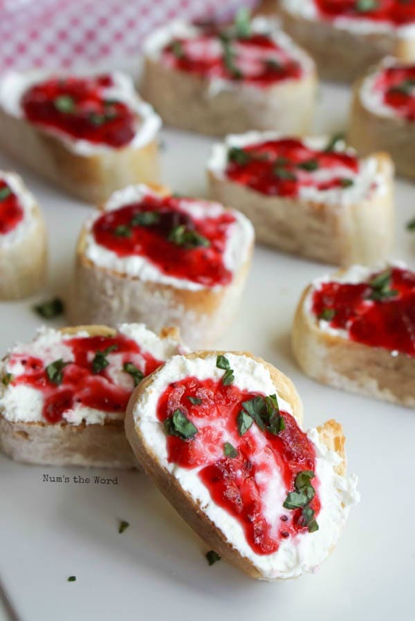 Leftover Cranberry Sauce Bruschetta - bruschetta on a platter with one propped up on another.