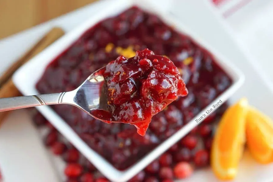 Orange Cranberry Sauce - spoon full of cranberry sauce ready to be eaten.