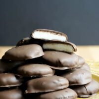 Leftover Mashed Potato Peppermint Patties - peppermint patties on a plate with one cut in half to see white center.