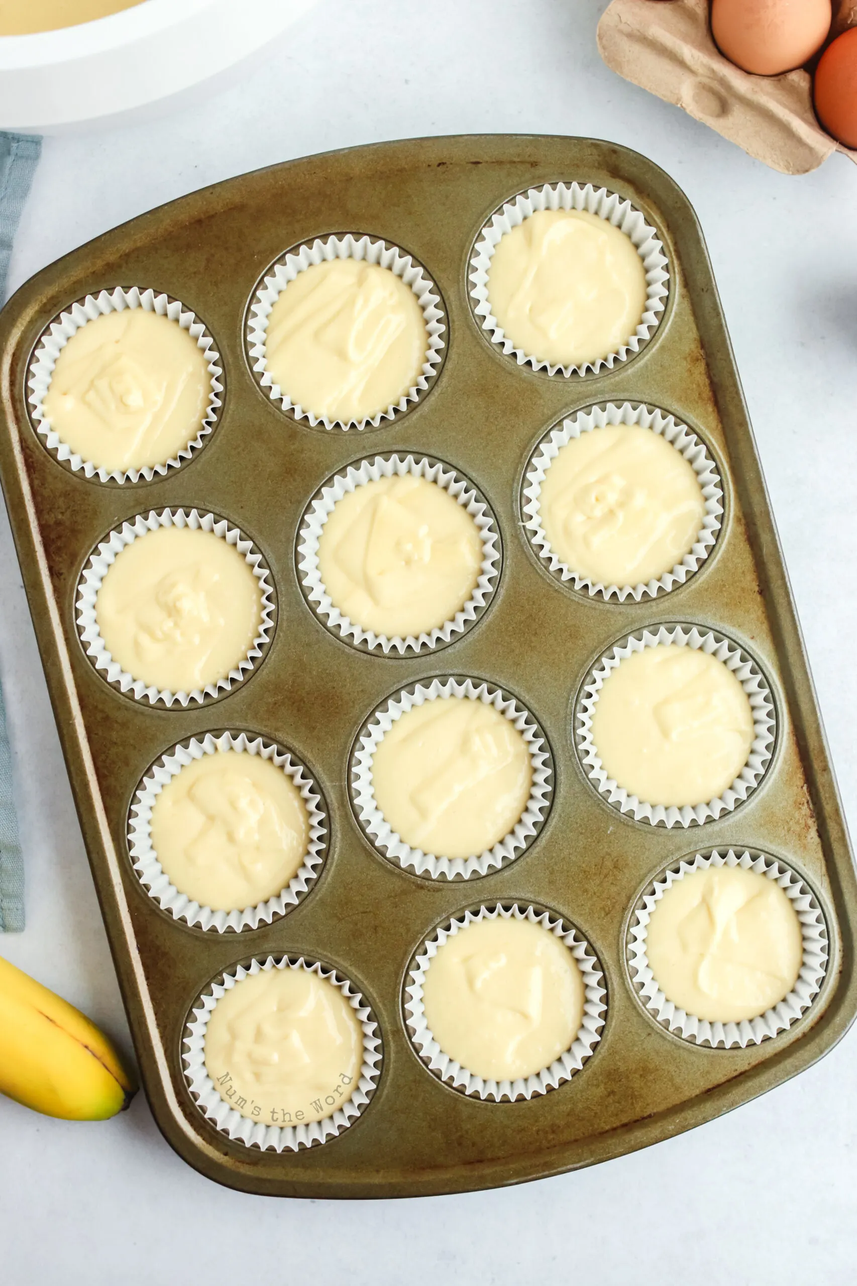 cupcake pan and liners filled with batter.