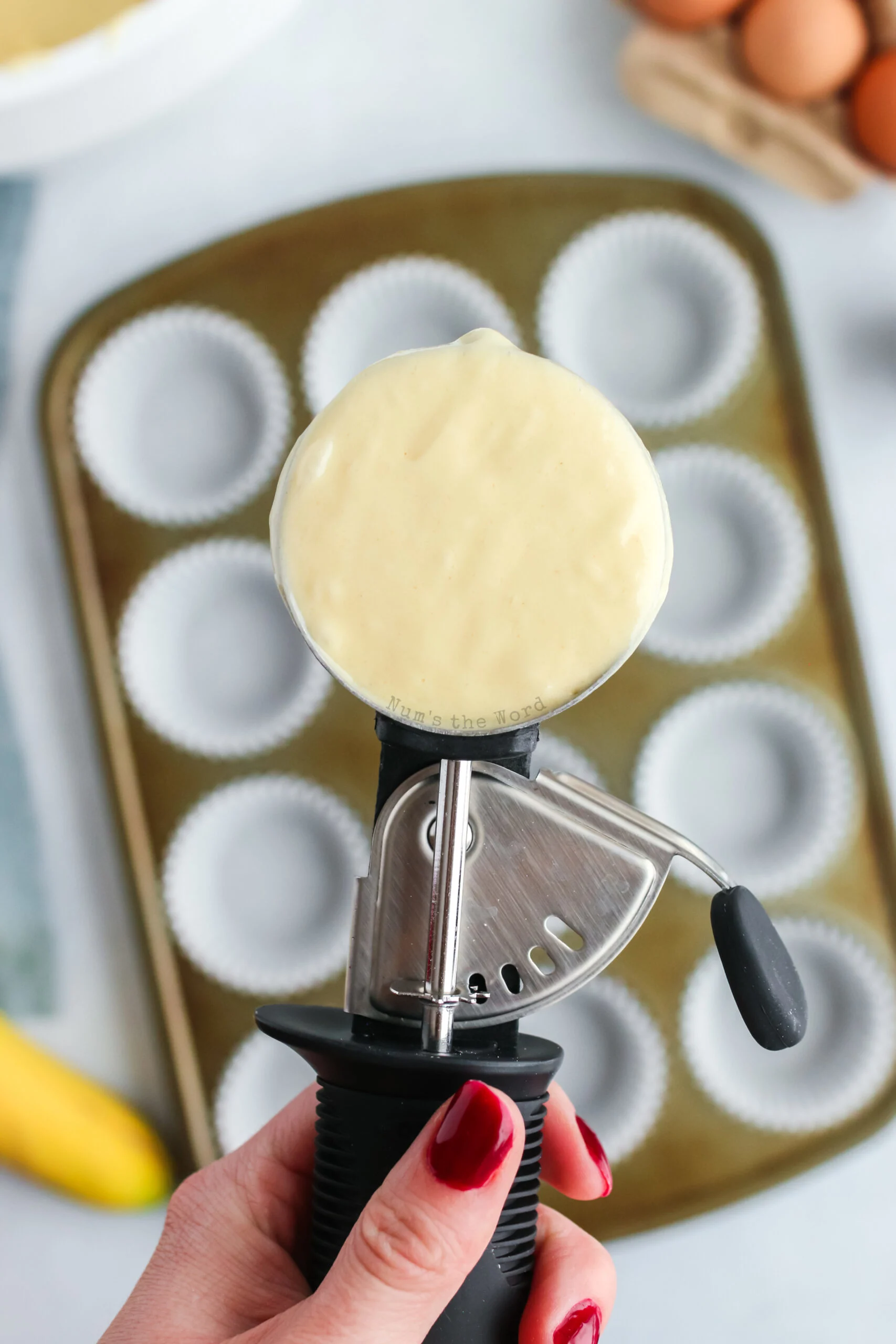 cupcake scoop filled with cupcake batter ready to fill cupcake liners