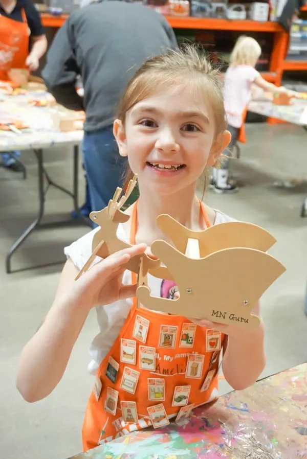 Home Depot Kids Workshop - smiling face showing off the project that is now built