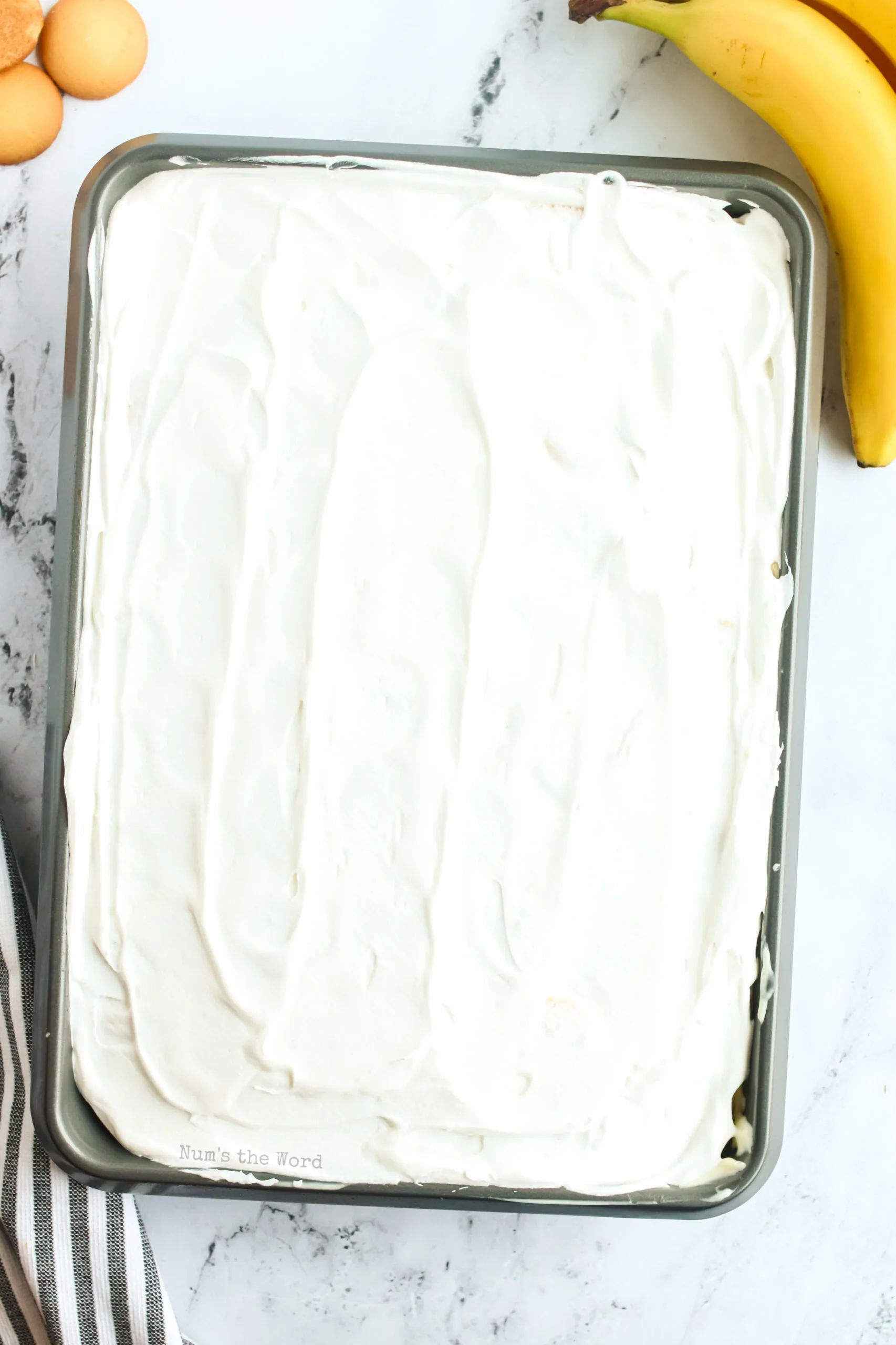 cool whip spread over bananas on cake