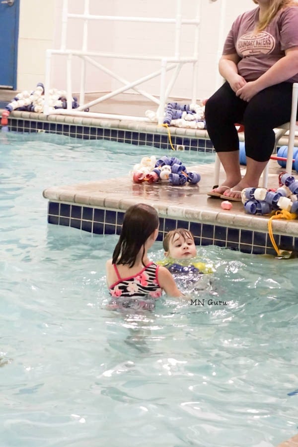 Jack Splash Open Swim - 2 kids swimming in pool with life guard sitting above them.