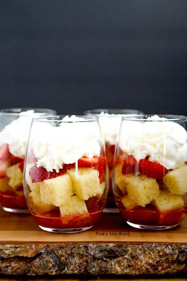 Strawberry Shortcake Trifle Cups - whipped cream placed on top of sliced strawberries