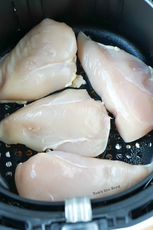 Air Fryer Chicken Breasts - raw chicken breasts in air fryer basket