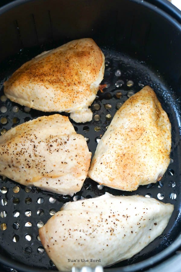 Air Fryer Chicken Breasts - chicken breasts cooked first round, ready to be flipped