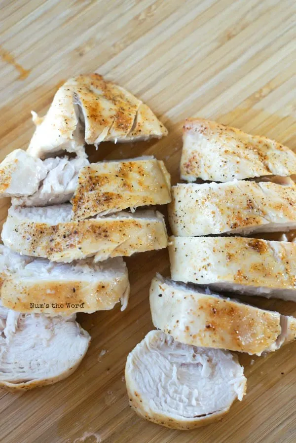 Air Fryer Chicken Breasts - cooked chicken breasts on cutting board, sliced